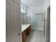 Bathroom with a double sink vanity, shower stall, tile floors, and white colored walls at 438 Fountain Grove St, Henderson, NV 89012