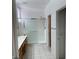Bathroom with sliding glass shower doors, tile floor, and wooden vanity at 438 Fountain Grove St, Henderson, NV 89012