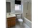 Bathroom features a shower-tub combo, oak vanity, and white tile floors at 438 Fountain Grove St, Henderson, NV 89012