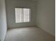 Bedroom with neutral carpet, white walls, and a window that brings in natural light at 438 Fountain Grove St, Henderson, NV 89012