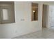 Bright living room featuring tile floors, large windows, and open view into another room at 438 Fountain Grove St, Henderson, NV 89012