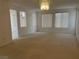 Spacious living room with neutral carpet, ample natural light, and decorative chandelier at 438 Fountain Grove St, Henderson, NV 89012