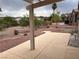 View of backyard from covered patio, with desert landscaping and wrought iron fence at 438 Fountain Grove St, Henderson, NV 89012