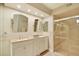Bathroom featuring double sinks, vanity, and a glass-enclosed shower at 4687 Madreperla St, Las Vegas, NV 89121