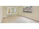 Carpeted bedroom featuring mirrored closet doors and a large window at 4687 Madreperla St, Las Vegas, NV 89121