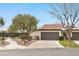 Single story home featuring desert landscaping, and a red tile roof, and two-car garage at 4687 Madreperla St, Las Vegas, NV 89121