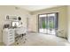 Bright home office with desk, chair, shelving and sliding door access to outdoor courtyard at 4687 Madreperla St, Las Vegas, NV 89121