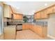 Well-maintained kitchen with ample maple cabinetry, granite countertops, and stainless steel appliances at 4687 Madreperla St, Las Vegas, NV 89121