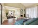 Open concept living room with a cozy fireplace, view into dining area, and lots of natural light at 4687 Madreperla St, Las Vegas, NV 89121