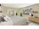 Bright bedroom with sliding mirror closet doors, neutral decor, and lots of natural light at 4687 Madreperla St, Las Vegas, NV 89121