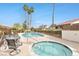 Relaxing community pool and jacuzzi surrounded by palm trees and lounge chairs at 4687 Madreperla St, Las Vegas, NV 89121