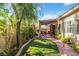 Relaxing backyard with covered patio, lush lawn, and mature landscaping at 4760 Verdet St, Las Vegas, NV 89147
