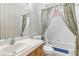 Charming bathroom showcasing a vanity, toilet, and bathtub with a floral curtain at 4760 Verdet St, Las Vegas, NV 89147