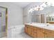 Well-lit bathroom featuring double sinks, a soaking tub, and a separate shower at 4760 Verdet St, Las Vegas, NV 89147