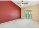 Spacious bedroom featuring plush carpeting, ceiling fan, and sliding glass doors to the outside at 4760 Verdet St, Las Vegas, NV 89147