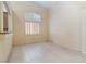 Empty room with large window with shutters and tile flooring at 4760 Verdet St, Las Vegas, NV 89147