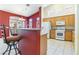 Modern kitchen with breakfast bar, white appliances, and ample cabinet space at 4760 Verdet St, Las Vegas, NV 89147