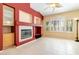 Bright living room featuring a fireplace, tile floors, and white shutters at 4760 Verdet St, Las Vegas, NV 89147