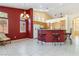 Open living space with breakfast bar, tile flooring, and a view of the backyard at 4760 Verdet St, Las Vegas, NV 89147