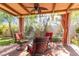 Cozy outdoor patio seating area with ceiling fan, drapes and misting system at 4760 Verdet St, Las Vegas, NV 89147