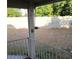 Backyard with gravel landscaping bordered by a concrete block wall, seen from covered patio at 500 Prescott St, Las Vegas, NV 89110