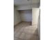 Cozy bedroom features neutral walls, tiled flooring, and a closet for storage at 500 Prescott St, Las Vegas, NV 89110