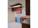 Well-lit kitchen featuring wooden cabinets, granite countertops, and tiled flooring at 500 Prescott St, Las Vegas, NV 89110