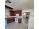 Well-lit kitchen featuring wooden cabinets, granite countertops, and tiled flooring at 500 Prescott St, Las Vegas, NV 89110