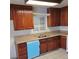 Well-lit kitchen featuring wooden cabinets, granite countertops, and tiled flooring at 500 Prescott St, Las Vegas, NV 89110