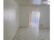 An open concept living room with tile floors and white walls leads to the adjacent dining area at 500 Prescott St, Las Vegas, NV 89110