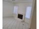 A view of the living room with windows and a brick fireplace with tile floors at 500 Prescott St, Las Vegas, NV 89110