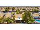 This aerial image showcases the property's tile roof, backyard pool, patio area, and surrounding neighborhood landscape with mature trees at 5104 Drummond Rd, Las Vegas, NV 89130