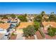 This aerial view highlights the home's well-maintained landscaping, tile roof, and proximity to neighborhood amenities and lush greenery at 5104 Drummond Rd, Las Vegas, NV 89130