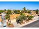 This aerial view shows the home’s well-manicured yard, complemented by a tile roof, and neighborhood scenery with mature trees at 5104 Drummond Rd, Las Vegas, NV 89130
