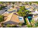 This aerial view highlights the home's tile roof, backyard pool, and neighborhood setting with mature trees and proximity to community amenities at 5104 Drummond Rd, Las Vegas, NV 89130