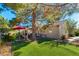 Charming backyard showcases a well-maintained lawn, mature trees, and patio area, perfect for outdoor enjoyment and relaxation at 5104 Drummond Rd, Las Vegas, NV 89130