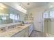Sparkling bathroom features dual sinks, a glass shower and bright lights at 5104 Drummond Rd, Las Vegas, NV 89130