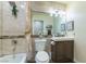 Well lit bathroom features a vanity, tub/shower and a large mirror at 5104 Drummond Rd, Las Vegas, NV 89130