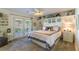 Calming bedroom features white furniture, ceiling fan and french doors that lead to a patio at 5104 Drummond Rd, Las Vegas, NV 89130