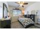 Snug bedroom with a ceiling fan, dresser and small built in bookcase near the bed at 5104 Drummond Rd, Las Vegas, NV 89130