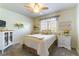 Comfortable bedroom with neutral tones, a ceiling fan and a view of the front yard at 5104 Drummond Rd, Las Vegas, NV 89130