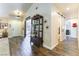 Stylish foyer with wood-look tile flooring, decorative shelving, and a view into multiple rooms at 5104 Drummond Rd, Las Vegas, NV 89130