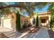 Charming single story home featuring desert landscaping, a covered front porch, and a two-car garage at 5104 Drummond Rd, Las Vegas, NV 89130