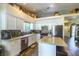 Well-lit kitchen featuring white cabinets, granite countertops, stainless steel appliances, and a kitchen island at 5104 Drummond Rd, Las Vegas, NV 89130