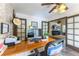 A fully equipped home office with a large desk, comfortable chair, and seamless access to the living room at 5104 Drummond Rd, Las Vegas, NV 89130