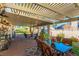 Spacious covered patio includes stylish outdoor furniture, a dining table, and a beautifully landscaped backyard for relaxation and entertaining at 5104 Drummond Rd, Las Vegas, NV 89130