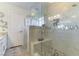 Modern shower with marble and mosaic tile, glass surround, and built in bench at 5104 Drummond Rd, Las Vegas, NV 89130