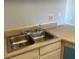 A stainless steel kitchen sink, faucet, and neutral countertops at 513 Kristin Ln, Henderson, NV 89011