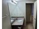 Well-lit bathroom with granite countertop, a mirror, and a view of the doorway at 5295 Indian River Dr # 305, Las Vegas, NV 89103
