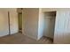 Cozy bedroom featuring neutral carpet and a spacious closet with sliding doors at 5295 Indian River Dr # 305, Las Vegas, NV 89103